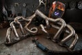 Custom exhaust manifold on welders work bench Royalty Free Stock Photo