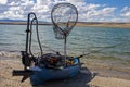 Custom fishing kayak with an electric trolley motor on shore of Lake Hattie, Wyoming