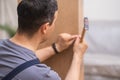 Custom furniture assembly master hammering nails into wooden panel close up