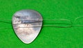 Custom Guitar Pick Threaded with String on Green Felt Royalty Free Stock Photo