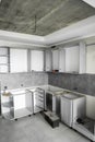 Custom kitchen cabinets installation without a furniture facades mdf. Gray modular kitchen from chipboard material on a Royalty Free Stock Photo