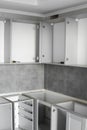 Custom kitchen cabinets installation without a furniture facades mdf. Gray modular kitchen from chipboard material on a Royalty Free Stock Photo