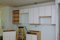 Custom kitchen cabinets in various stages of installation base for island in center Royalty Free Stock Photo