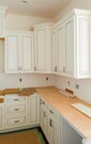 Custom kitchen cabinets in various stages of installation base for island in center Royalty Free Stock Photo