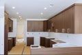 Custom kitchen cabinets in various stages of installation base for island in center Royalty Free Stock Photo