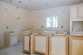 Custom kitchen cabinets in various stages of installation base for island in center Royalty Free Stock Photo