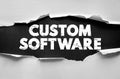 Custom Software message under torn paper. Concept for technology, programming, IT solutions, development, and digital service Royalty Free Stock Photo