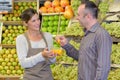 Customer accespting taster in fruit aisle