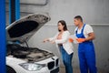 Customer asks mechanic to fix car engine Royalty Free Stock Photo