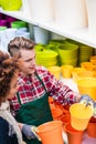 Customer buying plastic pots at the advice of a helpful worker Royalty Free Stock Photo