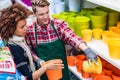 Customer buying plastic pots at the advice of a helpful worker