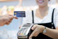 Customer in cafe is paying via the credit card to shop assistant. Royalty Free Stock Photo