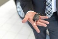 Customer in the car dealership holds the car key of the newly pu Royalty Free Stock Photo