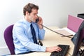 Customer care worker in an office on the telephone