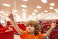 Customer child holdind trolley, shopping at supermarket, grocery store. Supermarket, Shopping with Child. Royalty Free Stock Photo