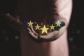 Customer or client satisfaction concept. hand holding the stars to five stars Royalty Free Stock Photo