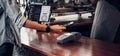 Customer contactless payment for drink with mobile phon at cafe counter bar,seller coffee shop accept payment by mobile.new normal Royalty Free Stock Photo