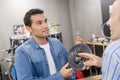customer enquiring about bicycle gear in shop Royalty Free Stock Photo