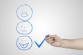 Customer experience concept. Hand putting check mark a checkbox on excellent smiley face rating for a satisfaction survey Royalty Free Stock Photo