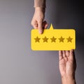 Customer Experience Concept  Happy Client giving Five Star Rating Feedback on Card to a Businessman Royalty Free Stock Photo