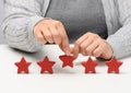 Customer experience feedback concept. Five red stars, the best rating of excellent services with a female hand to meet. White Royalty Free Stock Photo