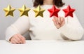 Customer experience feedback concept. Five red stars, the best rating of excellent services with a female hand to meet. White Royalty Free Stock Photo