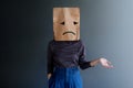 Customer Experience or Human Emotional Concept. Woman Covered her Face by Paper Bag and present Sadness Feeling and Disappointed
