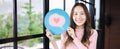Customer experience review and feedback satisfaction service concept. Woman holding love heart emoji for giving good feedback