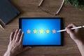 Customer experience satisfaction, feedback, review. Stars icon on device screen.