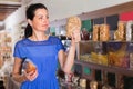 Customer female is choosing sweet dry fruits