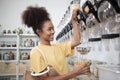 A customer fills cereal foods in a glass jar in a refill retail store