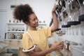 A customer fills cereal foods in a glass jar in a refill retail store