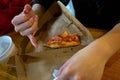 Customer Finishing Last Piece of Pizza in Box