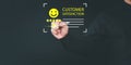 Customer give the point with a smile face icon to give satisfaction in opinion on virtual screen online application.