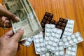 Customer giving money to buy drug at drugstore pharmacy. Close up view. Various capsules, tablets, Pills in medicine shop on table Royalty Free Stock Photo