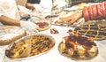 Customer hand choosing slice of pie at pastry confectionery shop