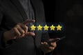 Customer hand hold five stars. Service rating, giving a five star rating. satisfaction concept Royalty Free Stock Photo