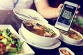 Customer hand using smart phone to scan QR code tag with blurry Thai food to accepted generate digital pay without money