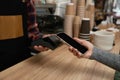 customer holding phone near nfc terminal make contactless payment. Royalty Free Stock Photo