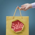 Customer holding a shopping bag with sale text Royalty Free Stock Photo