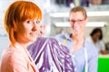 Customer in laundry shop or textile dry-cleaning Royalty Free Stock Photo