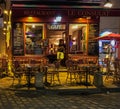 Customer leans in doorway of Le Consulat restaurant in Paris