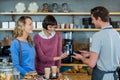 Customer making payment through payment terminal at counter Royalty Free Stock Photo