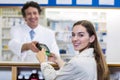 Customer making payment through payment terminal machine at pharmacy Royalty Free Stock Photo