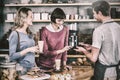 Customer making payment through payment terminal at counter Royalty Free Stock Photo