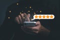 Customer man hand pressing on smartphone screen with gold five star rating feedback icon and press level excellent Royalty Free Stock Photo