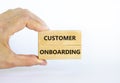 Customer onboarding success symbol. Wooden blocks with words `Customer onboarding` on beautiful white background. Businessman ha