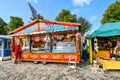 A customer orders from a colorful street vendor on the strand boardwalk waterfront promenade at Warnemunde, Germany