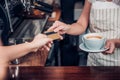 Customer pay coffee drink with credit card to barista,Close up h Royalty Free Stock Photo