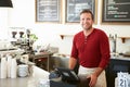 Customer Paying In Coffee Shop Using Touchscreen